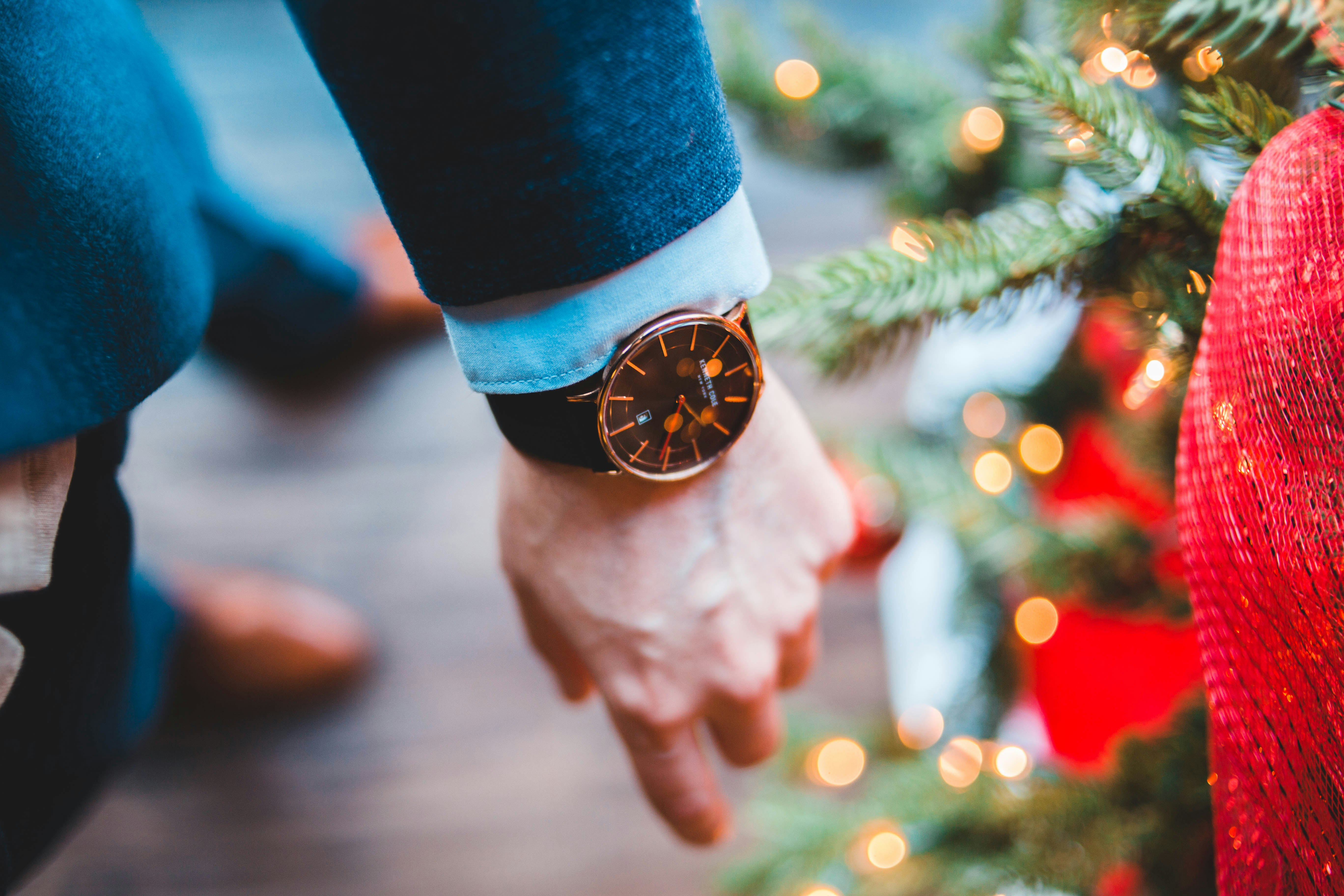 round black and gold-colored analog watch with black leather band